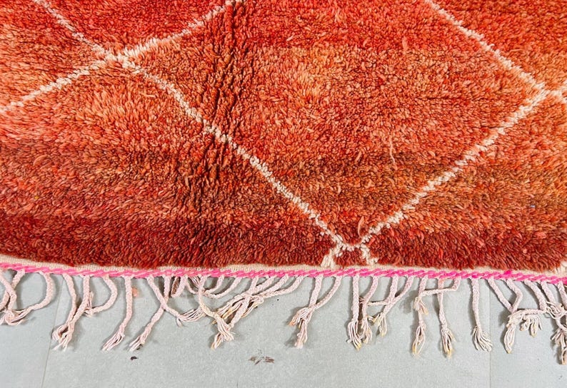 Red and white geometric rug perfect for modern boho decor.