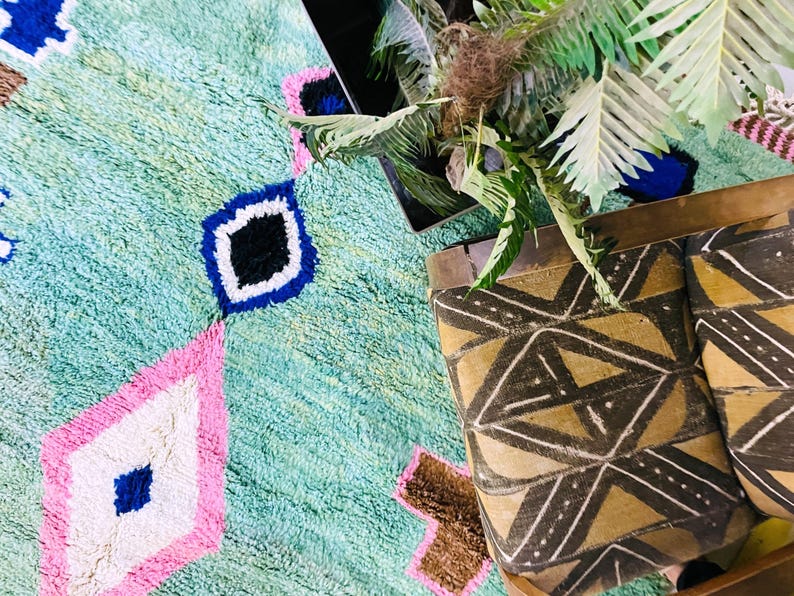 Unique artisan Berber rug with pink, blue, and brown details.