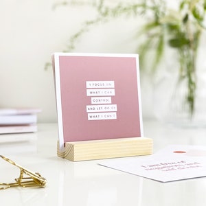 inspirational desk accessory displaying positive affirmation on a desk in a wooden holder