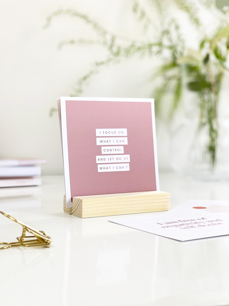 inspirational desk accessory displaying positive affirmation on a desk in a wooden holder