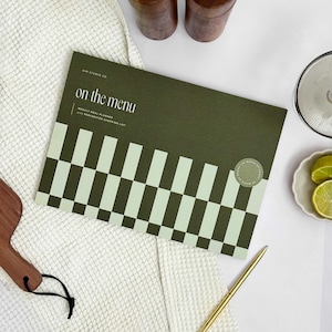 cover of perforated planner  pad for A4 weekly meal planning and writing shopping list. The cover is green with bold, geometric design.