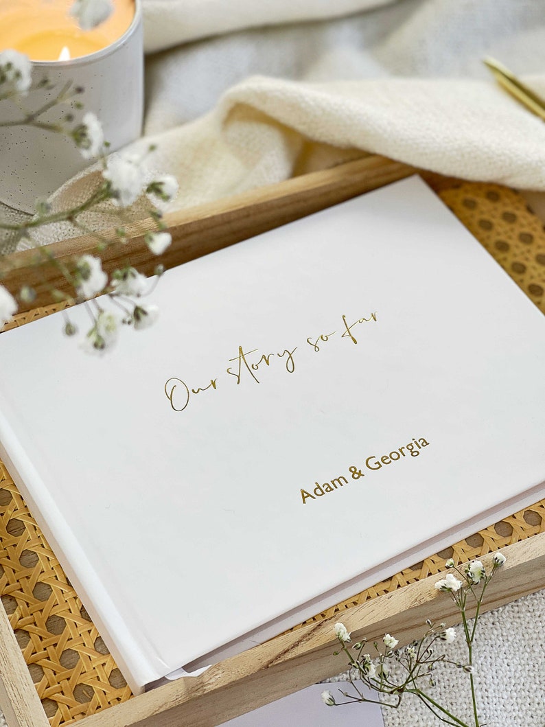 personalised hardcover memory book for couples with gold personalised names on the cover.