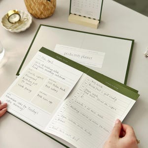 woman at office desk using daily task planner for productivity with time blocking pad for appointments and daily schedule