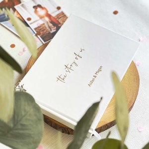 a white and gold foiled personalised scrapbook for couples
