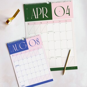 an A4 sized monthly planner on top of a large A3 wall calendar for 2027. Both calendars have the same colourful design with a retro aesthetic and spacious Monday-start planner grid, marked with UK bank holidays.
