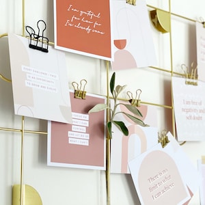 assortment of positive affirmations on a gold vision board aesthetic display
