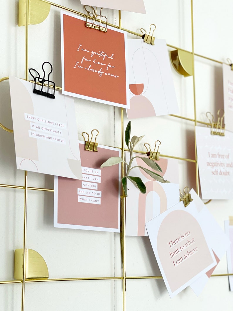 assortment of positive affirmations on a gold vision board aesthetic display