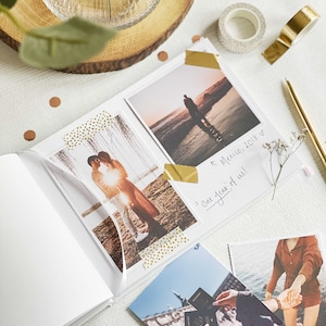 inside pages of memory book showing couples milestone memories with photos stuck using gold washi tape
