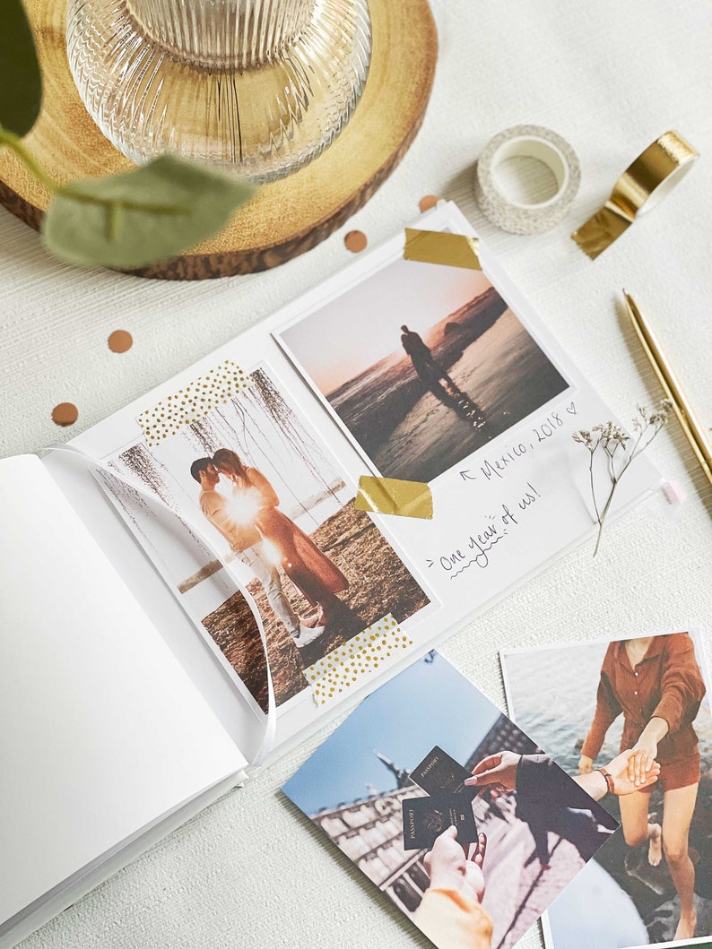 inside pages of memory book showing couples milestone memories with photos stuck using gold washi tape