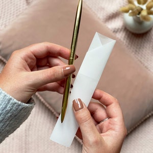 slim gold metal pen with luxury vellum envelope used for writing letters and advice to bride inside letters to bride book