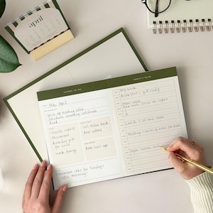 woman at office desk using a4 productivity planner for writing daily schedule and Time blocking tasks