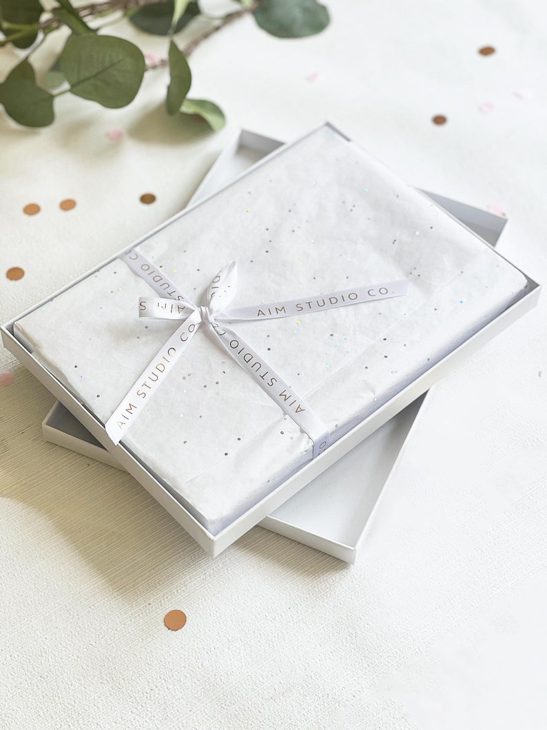 gift boxed coasters in white tissue wrap as a couples gift for valentines day or wedding present for newlywed mr and mrs