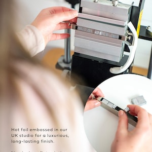 Behind the scenes process of making a letters to the bride scrapbook using a hot foil embossing machine to add custom text and personalised wedding date to the scrapbook cover.