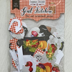 May include: A package of 50 die-cut cardstock pieces with a kitchen theme. The package is labeled "Soul Kitchen" and features a red and white gingham pattern. The pieces include various shapes, such as stars, hearts, and banners, with images of vegetables, fruits, and kitchen items.
