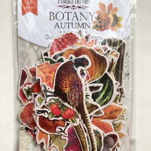 May include: A clear plastic package containing 56 die-cut paper pieces with an autumn theme. The pieces include leaves, pumpkins, berries, and a pheasant. The package has the words "Fabrika Decoru" and "Botany Autumn" printed on it.