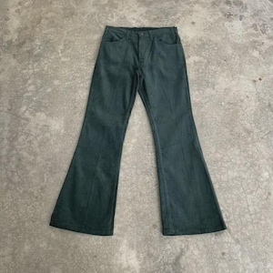 May include: Dark teal corduroy trousers with a flared leg. These trousers feature a classic five-pocket design and a button and zip fastening. The fabric appears to be soft corduroy.