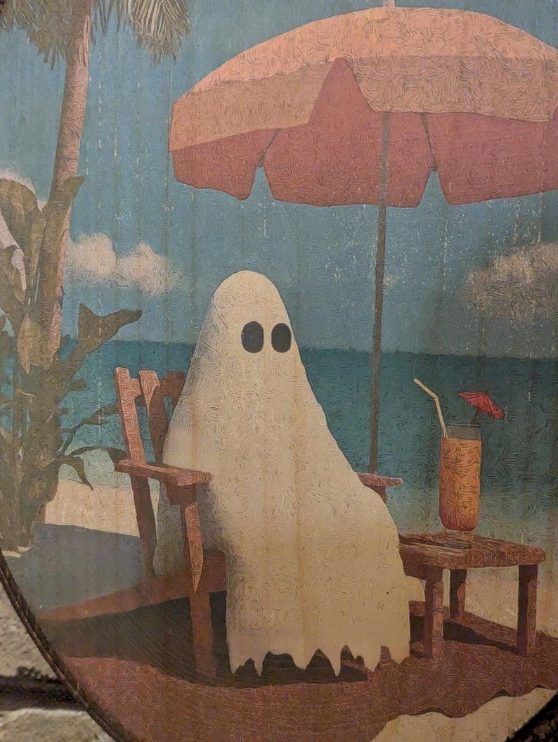 May include: A whimsical illustration depicts a ghost relaxing on a beach chair under a coral-colored umbrella. The ghost, with black oval eyes, enjoys a drink with a tiny umbrella. The background shows a beach scene with palm trees and blue skies.