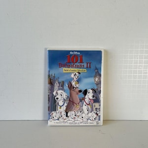 May include: DVD case for Disney's "101 Dalmatians II: Patch's London Adventure." The cover features a group of Dalmatian dogs in front of a London cityscape. The title and Disney logo are prominently displayed.