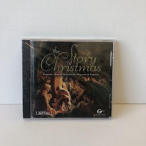 May include: A sealed CD case featuring "The Story of Christmas." The cover has a dark background with gold lettering and an illustration of a nativity scene. The LifeWay and Genevox logos are visible.