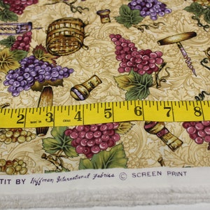 May include: A beige fabric with a repeating pattern of grapes, wine corks, and wine-related tools. The fabric has the text "BON APPETIT BY Hoffman International Fabrics © SCREEN PRINT" printed on the bottom.