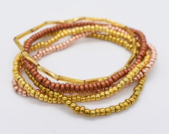 Braccialetto elastico con perline di semi d'oro, set da 5