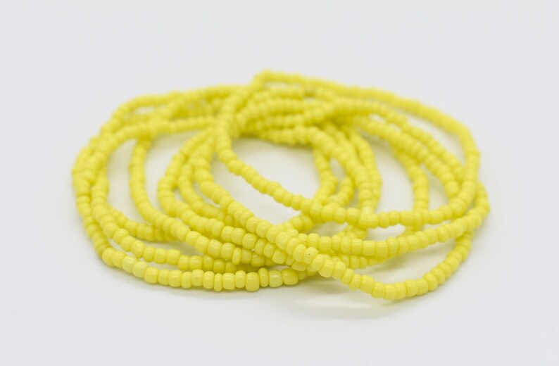 May include: A yellow beaded waist beads, also known as waist beads or belly beads, are a string of beads worn around the waist.