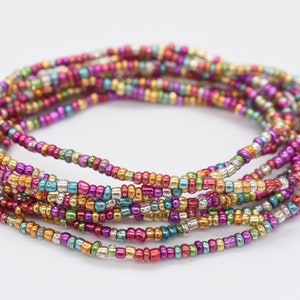 May include: A multi-colored beaded bracelet with a variety of metallic finishes, including silver, gold, and copper.