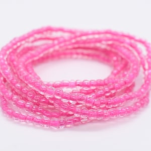 May include: A pink beaded bracelet made of small, round beads. The bracelet is wrapped around itself multiple times, creating a thick, layered look.