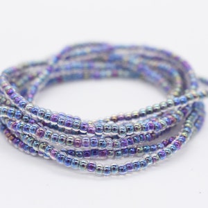May include: A close-up of a multi-strand beaded bracelet with iridescent blue and purple beads.