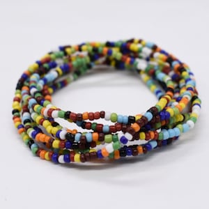 May include: A multi-colored beaded bracelet with a variety of colors including red, orange, yellow, green, blue, brown, black, and white.
