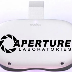 May include: A white Oculus VR headset with a black Aperture Laboratories logo and the Aperture Science logo. The logo includes the text "Aperture Laboratories".