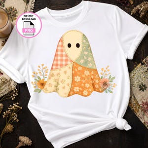 May include: A white short-sleeve t-shirt featuring a central graphic of a ghost made of patchwork fabric patterns in orange, cream, and sage green, accented by two black circular eyes and floral sprigs on both sides. Includes an instant download PNG icon.