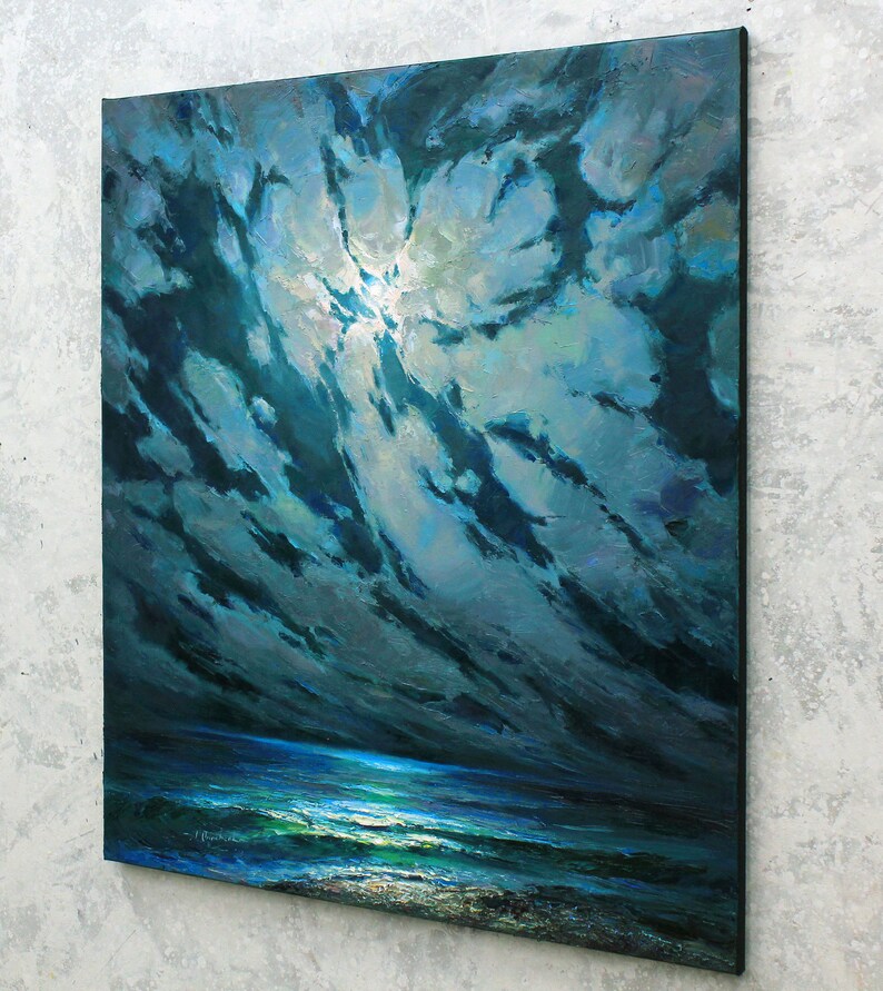 May include: A painting of a dark blue ocean scene with a bright white moon shining through dark blue clouds. The ocean is a deep blue with white waves and a light blue horizon.