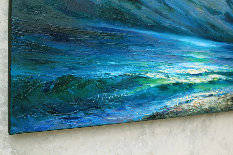 May include: A close-up of an abstract oil painting depicting a stormy seascape with deep blue and green hues. The artist's signature, "I.  Oripchenko", is visible in the lower right corner.