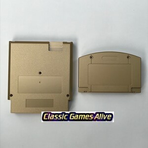 May include: Two gold-colored video game cartridges. One is rectangular, the other is more rounded. The text "Classic Games Alive" is at the bottom of the image.