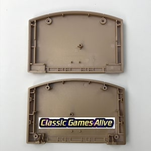 May include: Two tan-colored plastic Nintendo 64 game cartridge shells. The bottom shell has the text "Classic Games Alive" in a white and gold font. The shells are empty and ready for assembly.