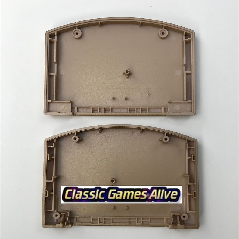 May include: Two tan-colored plastic Nintendo 64 game cartridge shells. The bottom shell has the text "Classic Games Alive" in a white and gold font. The shells are empty and ready for assembly.