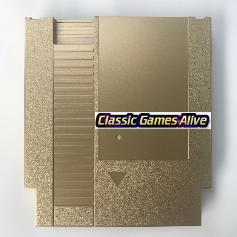 May include: A gold-colored video game cartridge with the text "Classic Games Alive" on a white label. The cartridge has a rectangular shape with a textured surface and a triangular indentation.