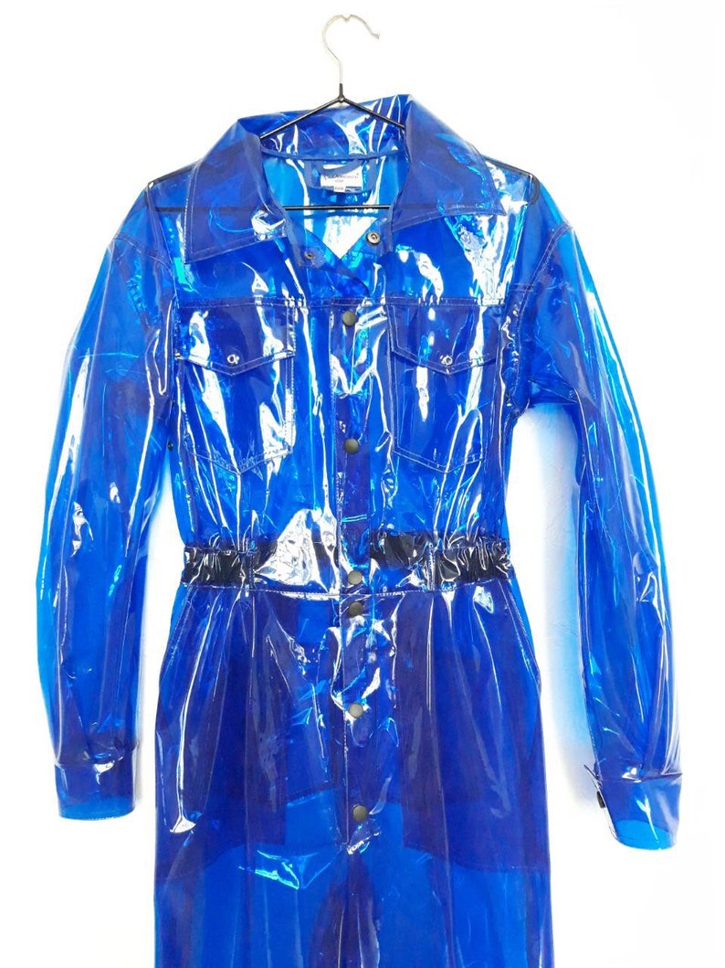 A transparent blue unisex overall Domdrich with a button-up front, long sleeves, and a black elastic waistband.