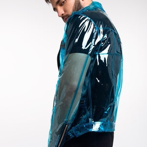 May include: A blue transparent jacket with a zip fastening and a black t-shirt underneath.