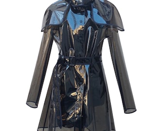 May include: A black transparent raincoat with a hood and a black belt. The raincoat has a cape-like design and a fitted silhouette.