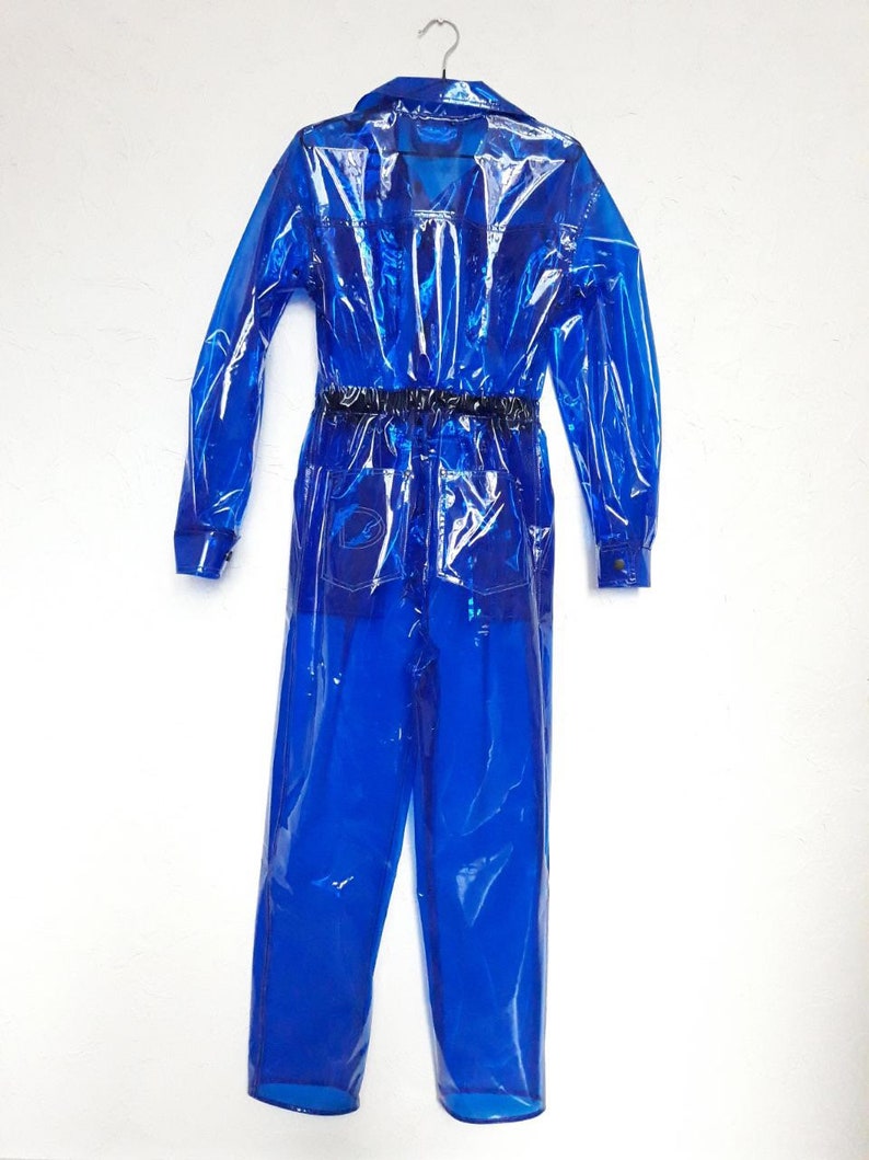 A bright blue, transparent overall with a collared shirt and long sleeves. The jumpsuit has a rubber belt and pockets.