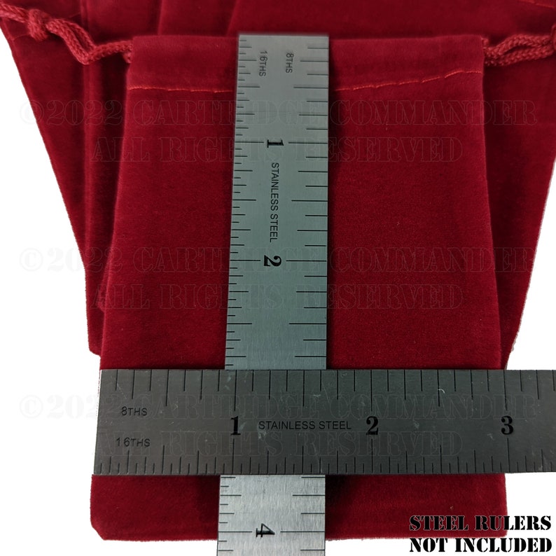 May include: Close-up of three red velvet drawstring pouches. A stainless steel ruler is placed across the pouches, showing measurements in inches. The text "STEEL RULERS NOT INCLUDED" is visible at the bottom.