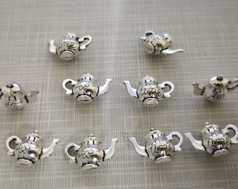 May include: A collection of small, silver-colored teapot charms. Each charm features a detailed design, including a spout, handle, and lid. Some teapots have the word "time" on them. These charms are ideal for jewelry making or crafting.