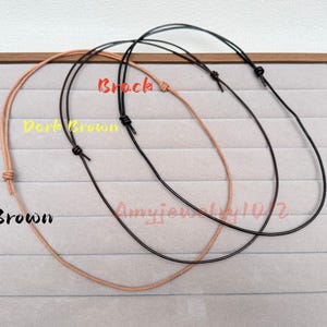 May include: Three thin cord necklaces in brown, dark brown, and black. Each necklace features a simple adjustable sliding knot mechanism. The text labels Brown, Dark Brown, and Black are visible, along with the watermark text Amyjewelry1012.