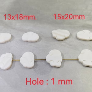 May include: White cloud-shaped beads with a 1 mm hole. The beads are available in two sizes: 13 x 18 mm and 15 x 20 mm.