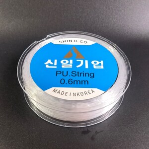 May include: A spool of clear, white, 0.6mm PU string, labeled "Shin Il Co. 신일기업 PU.String 0.6mm MADE IN KOREA".