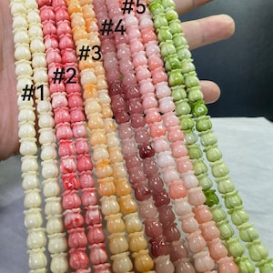 May include: A set of ten strands of flower-shaped beads in various pastel colors, including white, pink, peach, and green. The beads are numbered 1 through 6.