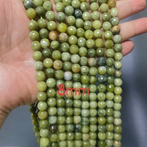 May include: A strand of 8mm green gemstone beads. The beads are round and have a faceted finish.