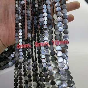 May include: A strand of black and grey heart-shaped shell beads in three sizes: 6mm, 8mm, and 10mm.